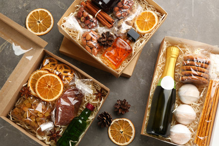 Boxes with stylish craft gift sets on gray table, flat layの写真素材