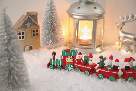 Toy train and Christmas decor on snowの写真素材