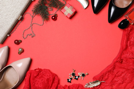 Christmas gift set with sexy women lingerie on red background, flat lay. Space for textの写真素材