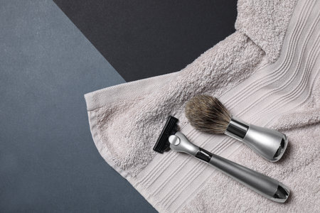 Razor, brush and towel for shaving on dark background, flat layの写真素材