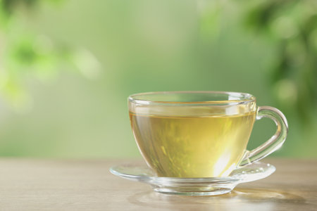 Glass cup of fresh herbal tea on table. Space for textの写真素材