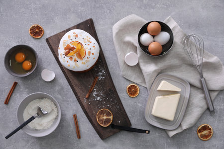 Flat lay composition with Easter cake and ingredients on light gray tableの写真素材