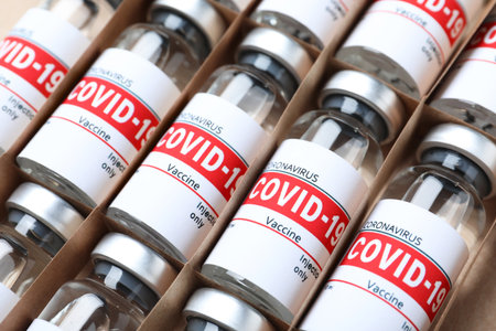 Glass vials with COVID-19 vaccine in package, closeupの写真素材