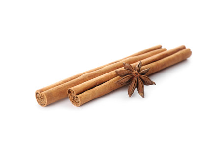 Aromatic cinnamon sticks and anise isolated on whiteの写真素材