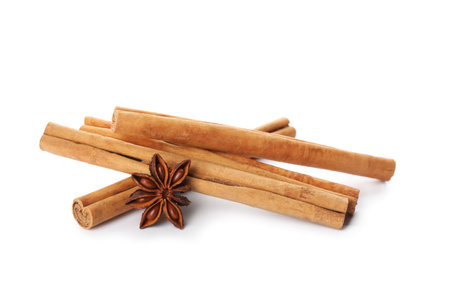 Aromatic cinnamon sticks and anise isolated on whiteの写真素材