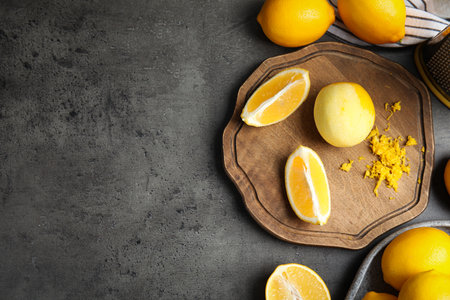 Lemon zest and fresh fruits on gray table, flat lay. Space for textの写真素材