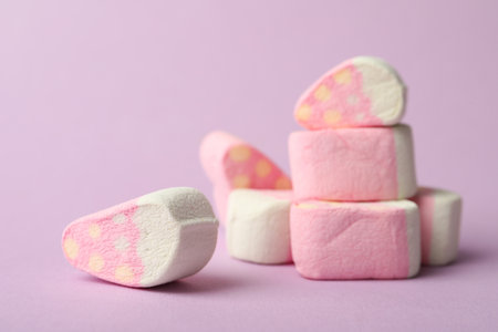 Pile of strawberry shaped marshmallows on pink background, closeup. Space for textの写真素材