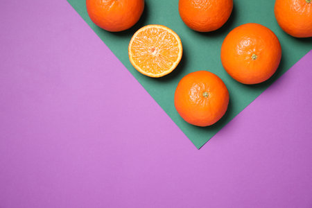 Fresh ripe tangerines on color background, flat lay. Space for textの写真素材