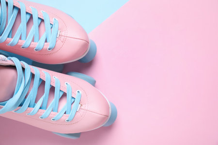Pair of stylish quad roller skates on color background, flat lay. Space for text