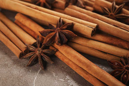 Aromatic cinnamon sticks and anise on gray marble table, closeupの写真素材