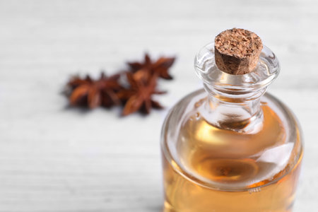 Bottle of anise essential oil, closeup. Space for text