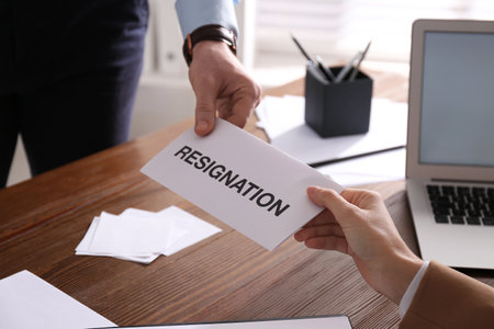 Employee giving resignation letter to boss in office, closeupの写真素材
