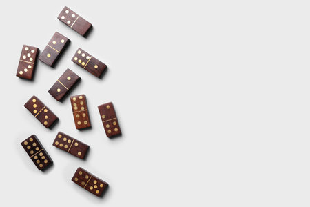 Wooden domino tiles on white background, flat lay. Space for textの写真素材