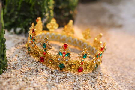 Beautiful golden crown on sand outdoors, closeup. fantasy itemの写真素材
