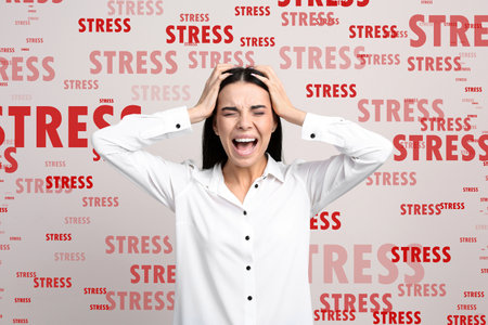 Stressed young woman and text on light backgroundの写真素材