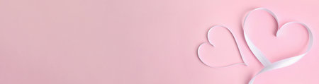 Hearts made of white ribbon on pink background, flat lay. Valentine's Day banner designの写真素材