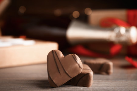 Tasty heart shaped chocolate candies on wooden table, closeup. happy valentines dayの写真素材