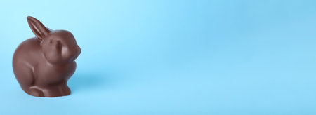 Chocolate Easter bunny on light blue background, space for textの写真素材