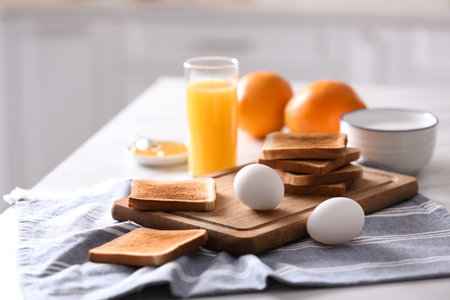 Delicious breakfast with toasts on the table in the kitchen