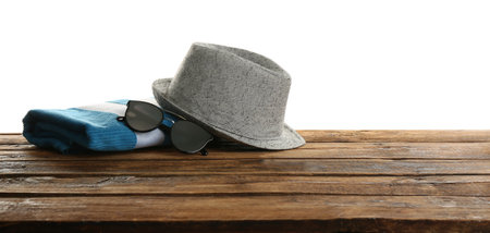 Hat, sunglasses and towel on wooden table, space for text. beach accessoriesの写真素材