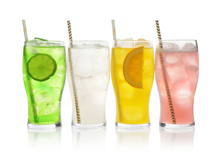 Delicious refreshing drinks in glasses on white backgroundの写真素材