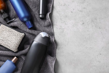 Flat lay composition with men's cosmetics on light gray stone background. Space for textの写真素材