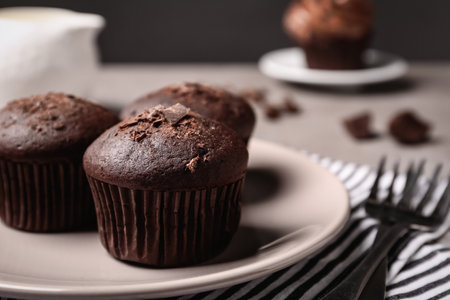 Delicious chocolate muffins served on table, closeup. Space for textの写真素材