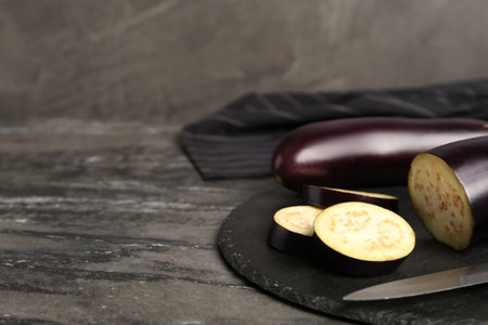 Fresh eggplants on gray table, closeup. Space for textの写真素材