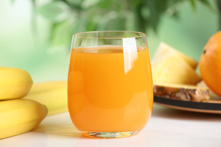 Yummy juice in glass on white table, closeupの写真素材