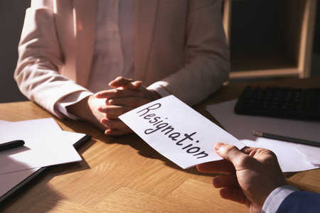 Employee giving resignation letter to boss in office, closeupの写真素材