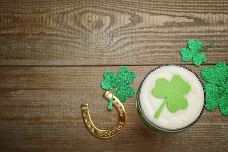 Beer and St Patrick's Day decor on wooden table, flat lay. Space for textの写真素材