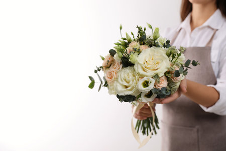 Florist holding beautiful wedding bouquet on white background, closeupの写真素材