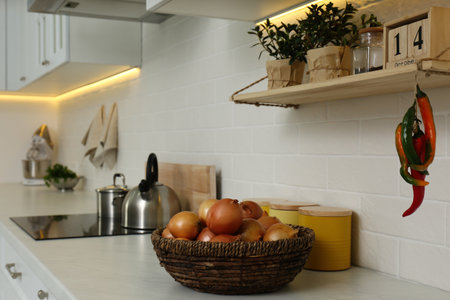 Fresh onions on countertop in modern kitchen