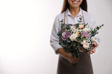 Florist holding beautiful wedding bouquet on white background, closeupの写真素材