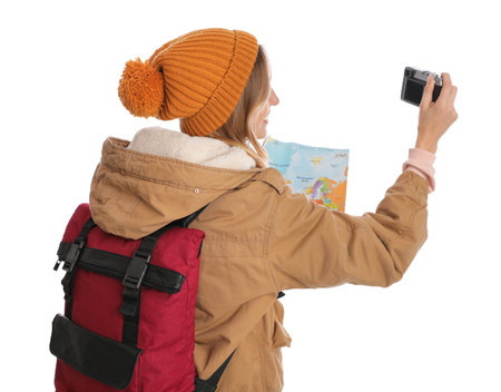 Woman with map and backpack taking picture on white background. winter travelの写真素材