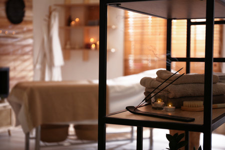 Aromatic incense sticks, burning candles and towels in spa salon. interior designの写真素材