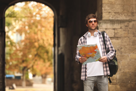 Traveler with world map on city streetの写真素材