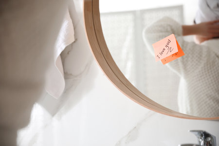 Sticky note with handwritten text I Love You on mirror in bathroom. romantic messageの写真素材