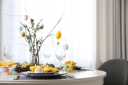 Beautiful Easter table setting with floral decor indoorsの写真素材