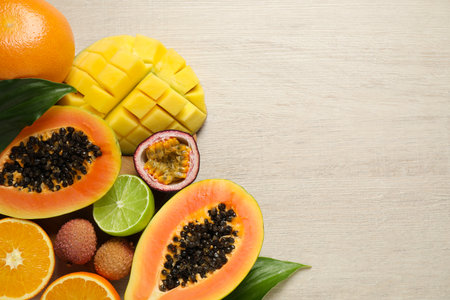 Fresh ripe papaya and other fruits on white wooden table, flat lay. Space for textの写真素材