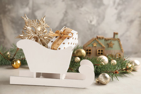 Beautiful Christmas composition with miniature sleigh on light tableの写真素材