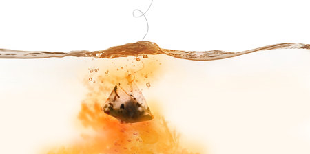 Dipping of tea bag into hot water against white background, banner designの写真素材