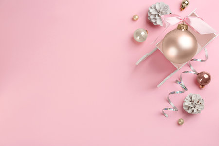 Beautiful Christmas composition with miniature sleigh on pink background, flat lay. Space for textの写真素材