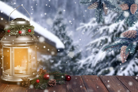 Decorated Christmas lantern with burning candle outdoors. Space for textの写真素材