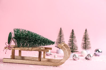 Beautiful Christmas composition with miniature sleigh on pink backgroundの写真素材
