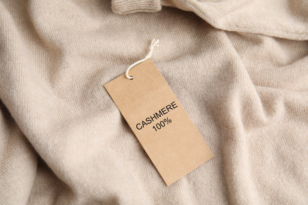 Warm beige cashmere sweater with label, closeupの写真素材