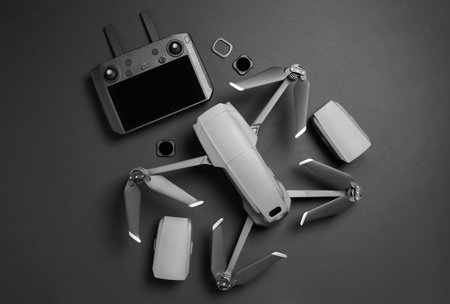 Modern drone with camera and video production equipment on black background, flat layの写真素材