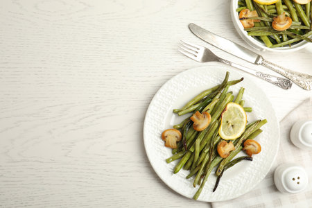 Delicious baked green beans served on a white table. Space for textの写真素材