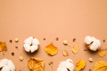 Flat lay composition with autumn leaves on beige background, space for textの写真素材