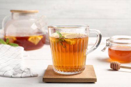 Hot tea with mint and lemon slices on white table, closeupの写真素材